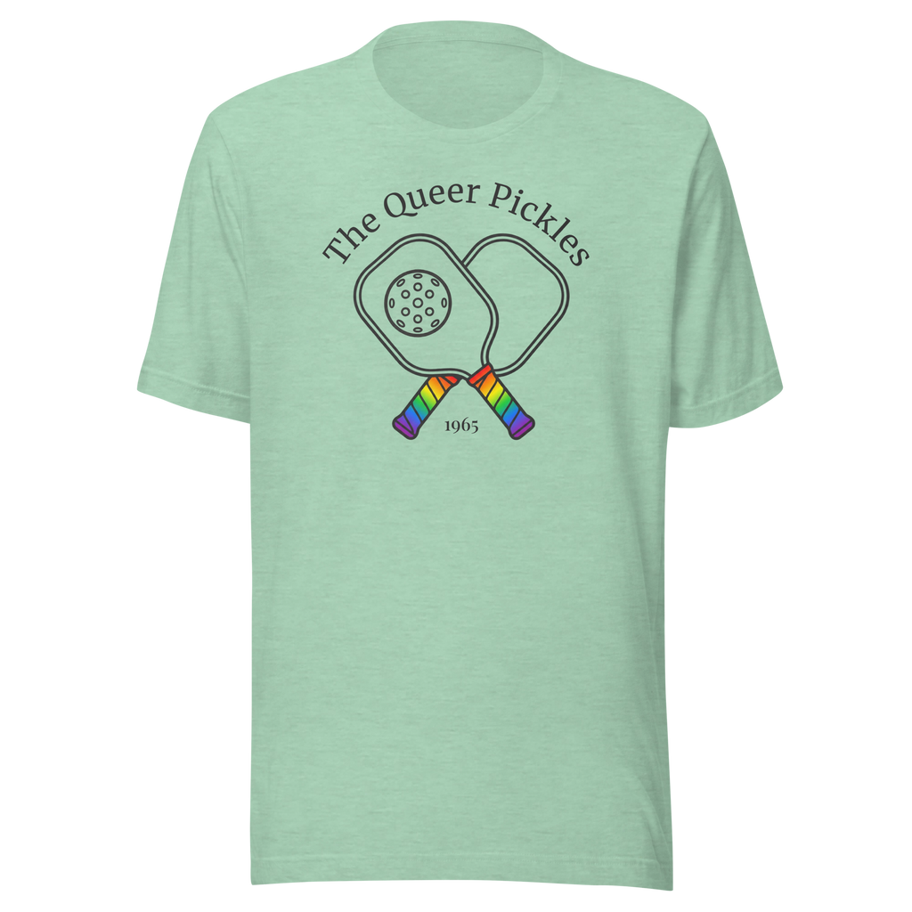 The Queer Pickles above 2 crossed paddles with pickleball,  with 1965 club style. Printed on unisex Bella + Canvas heather prism mint tshirt. Center Chest black in and rainbow handles.