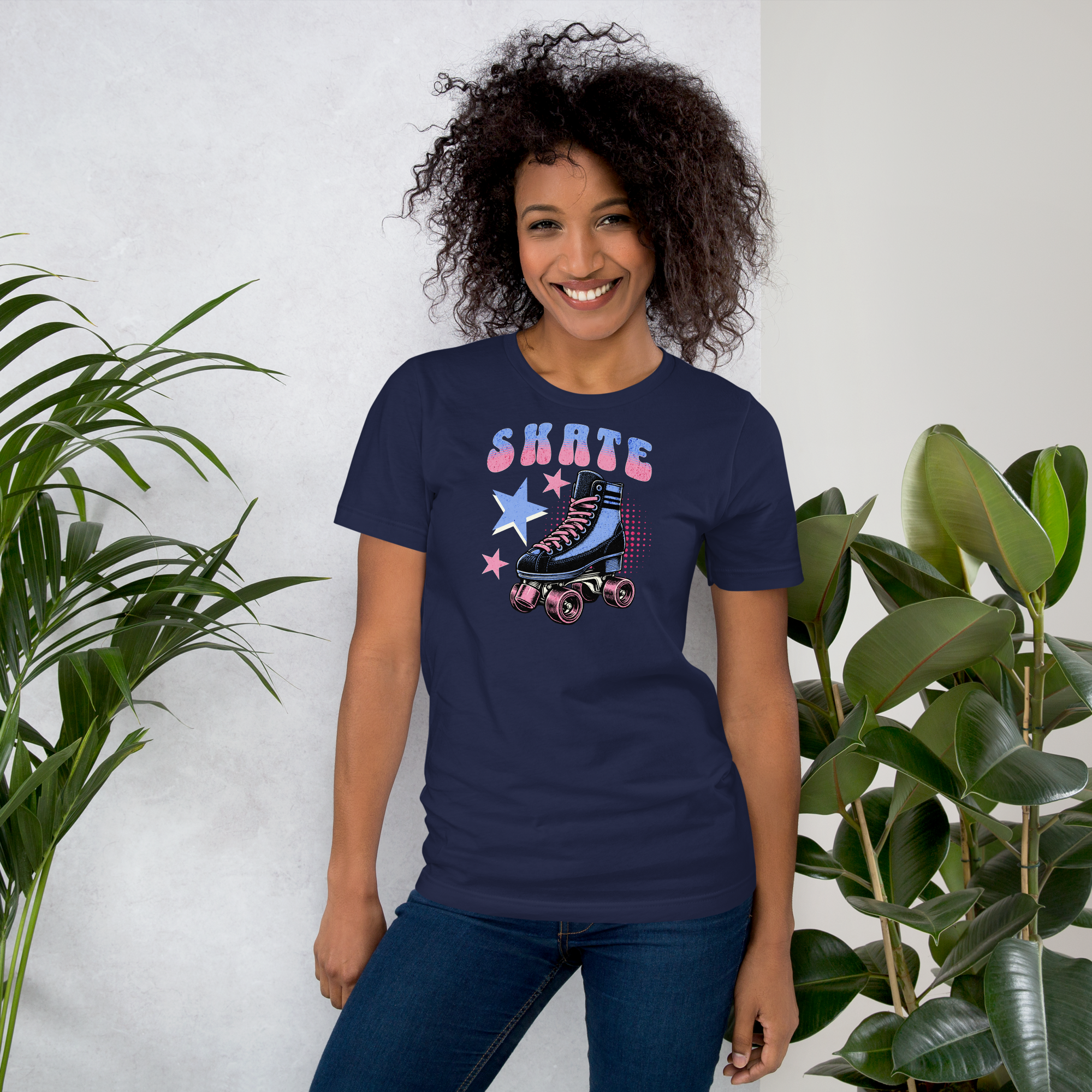 Model wearing skate in retro typography in blue and pink above a classic quad skate also in blue and pink on navy bella + canvas unisex tee. Paired with jeggings.