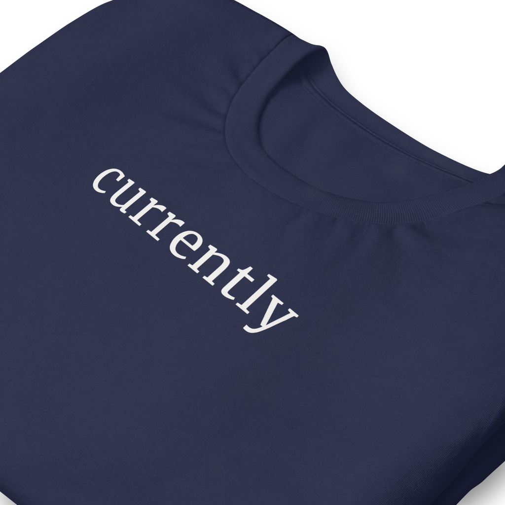 Currently in clean bold font, white ink, printed on Bella + Canvas cotton navy blue tshirt.  high Center chest, zoomed in