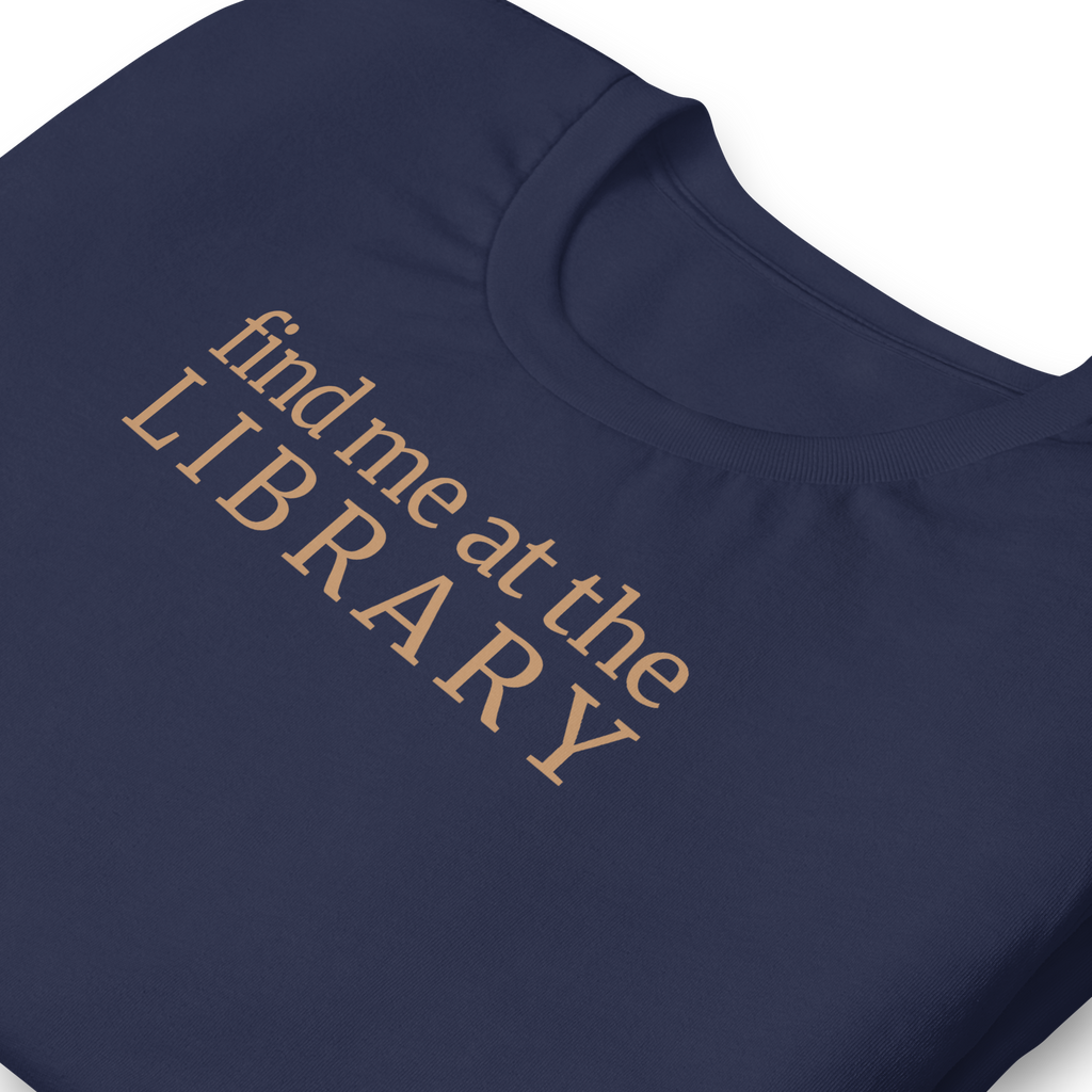 "Find Me at the Library" minimalist typography tee. On Bella + Canvas unisex cotton. Terra cotta ink on navy blue shirt. close up.