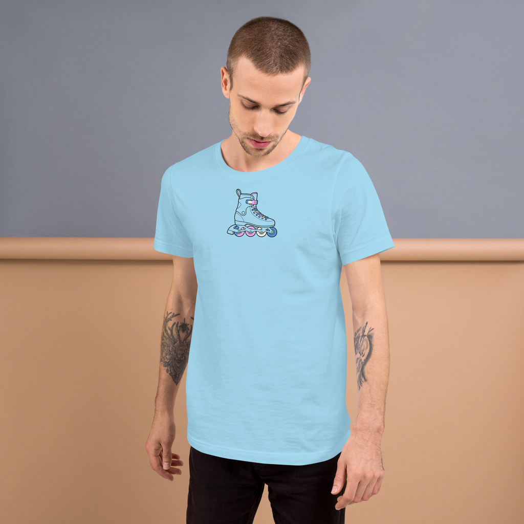 Model wearing High Center chest inline skate graphic. Minimalist line drawing outline with the laces and wheels in  trans Blue, pink, and white. Soft unisex Bella Canvas blue cotton. 