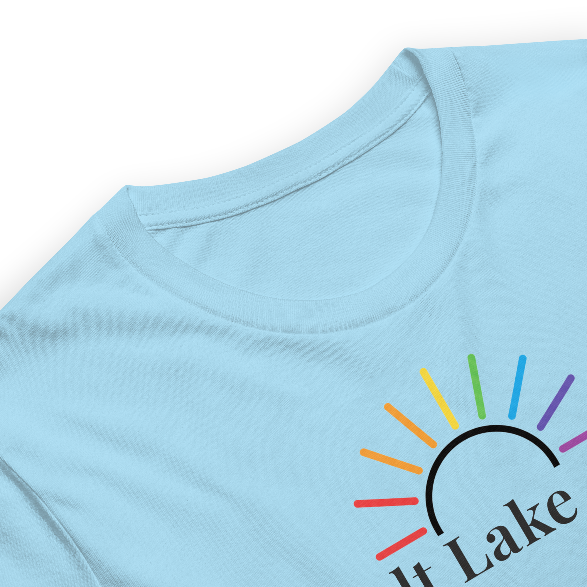 Rainbow sun arc above Salt Lake City typography on soft Bella + Canvas unisex shirt. Ocean blue cotton, center chest, close up collar