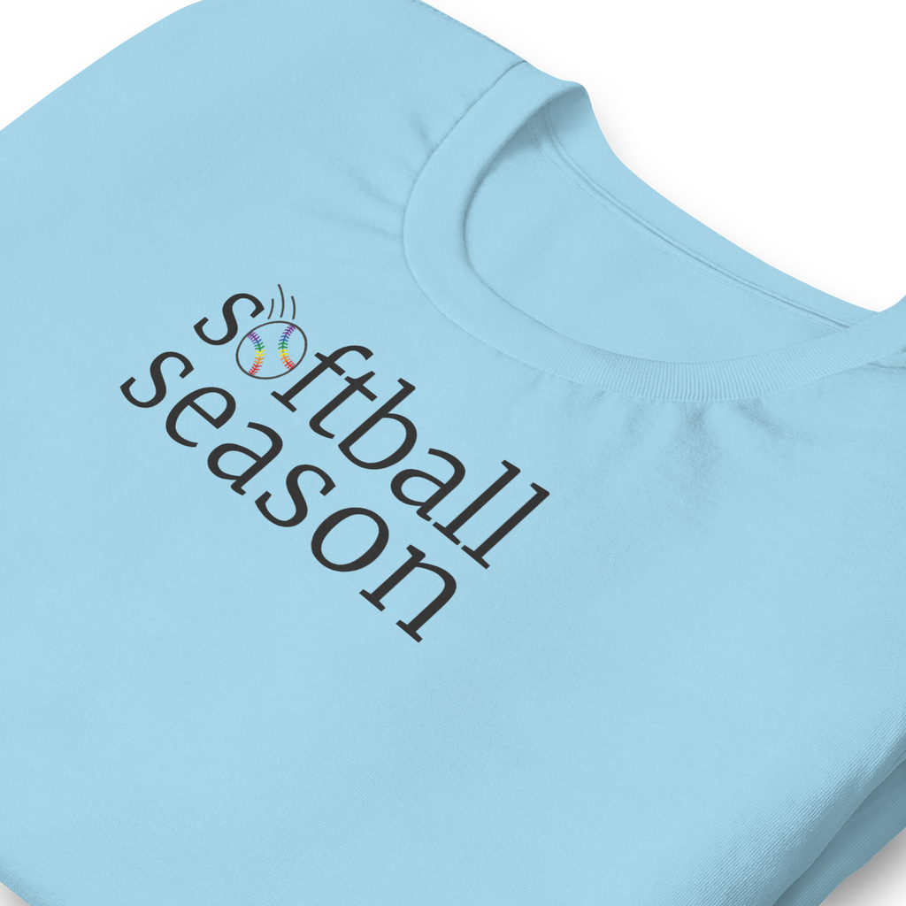 Minimalist typography "softball season" with the O replaced by a rainbow softball graphic. Off black ink on unisex  Bella + Canvas athletic heather grey shirt. Center chest. Zoomed in