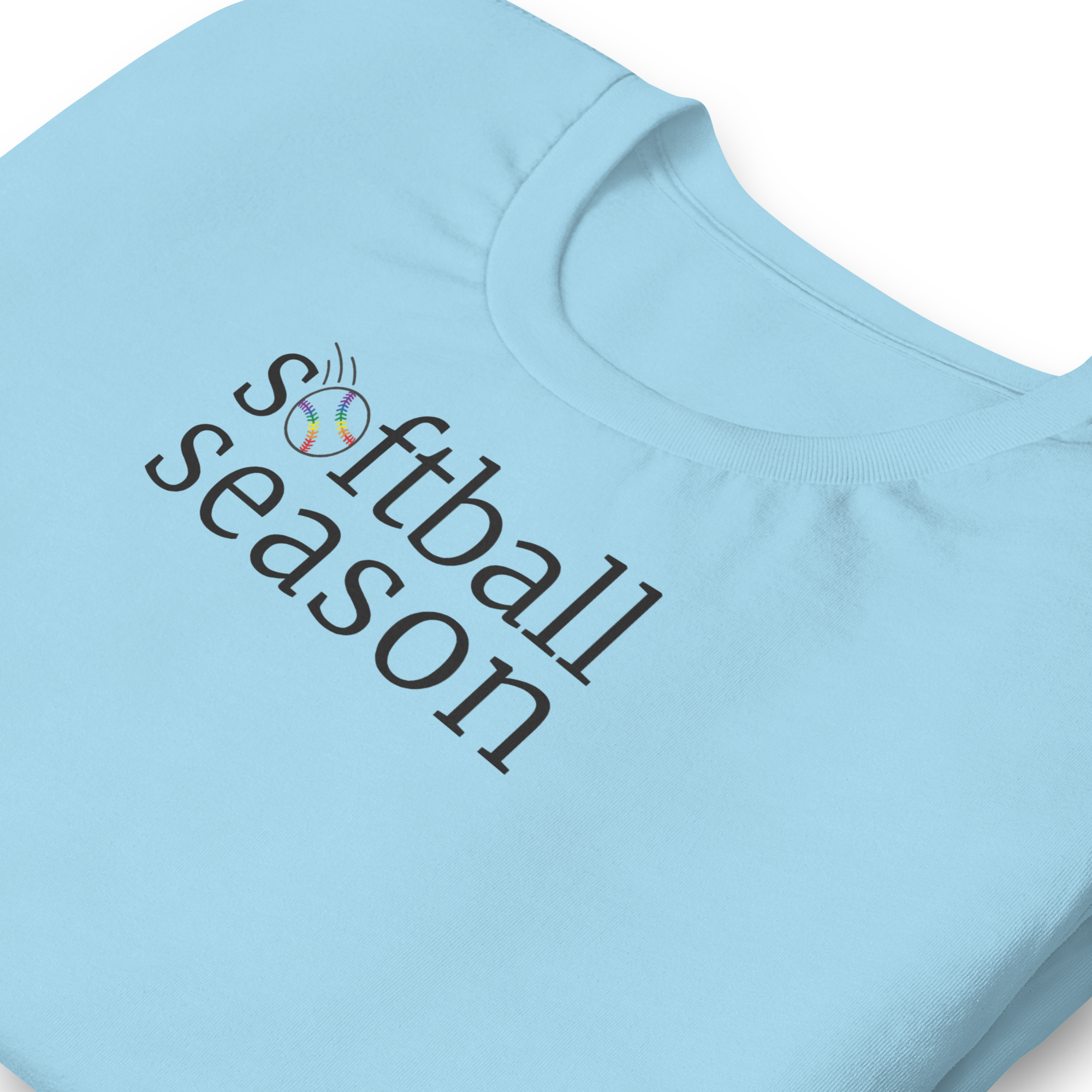 Minimalist typography "softball season" with the O replaced by a rainbow softball graphic. Off black ink on unisex  Bella + Canvas athletic heather grey shirt. Center chest. Zoomed in