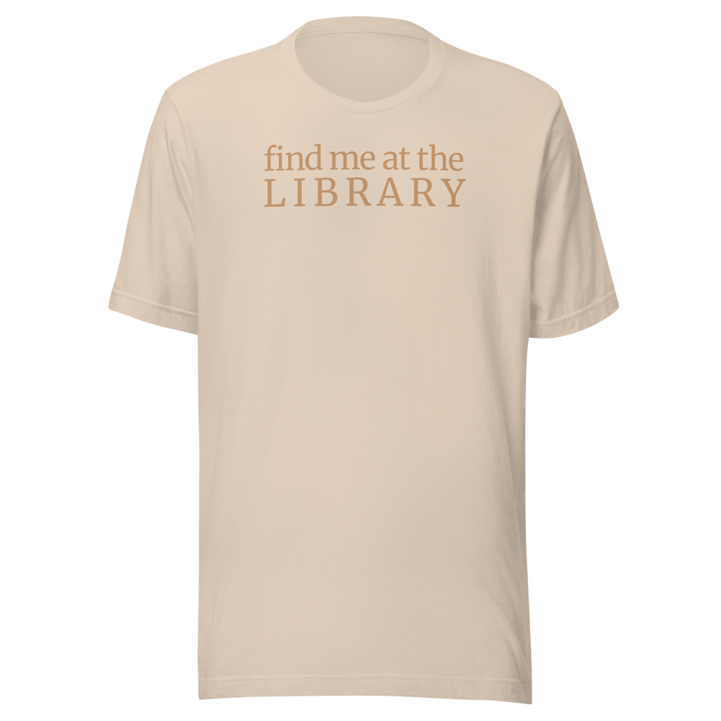 "Find Me at the Library" minimalist typography tee. On Bella + Canvas unisex cotton. Terra cotta ink on soft cream beige shirt