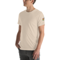 Model wearing beige shirt with outline of 2 quad skates with LGBTQ+ rainbow laces. Printed on left sleeve paired with jeans. Bella + canvas unisex cotton