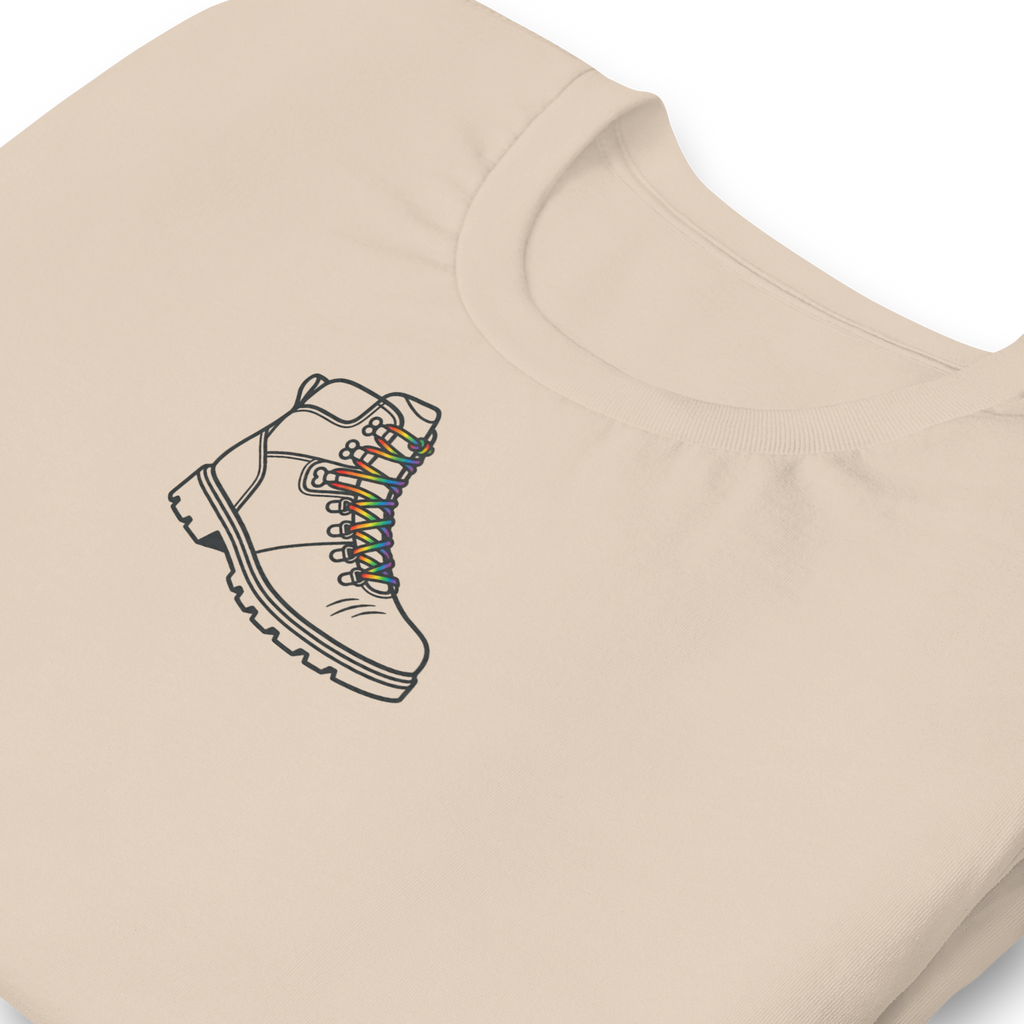 Minimalist Rainbow Hiking boot, upper center chest on Bella + Canvas soft cream cotton unisex tshirt. zoomed in
